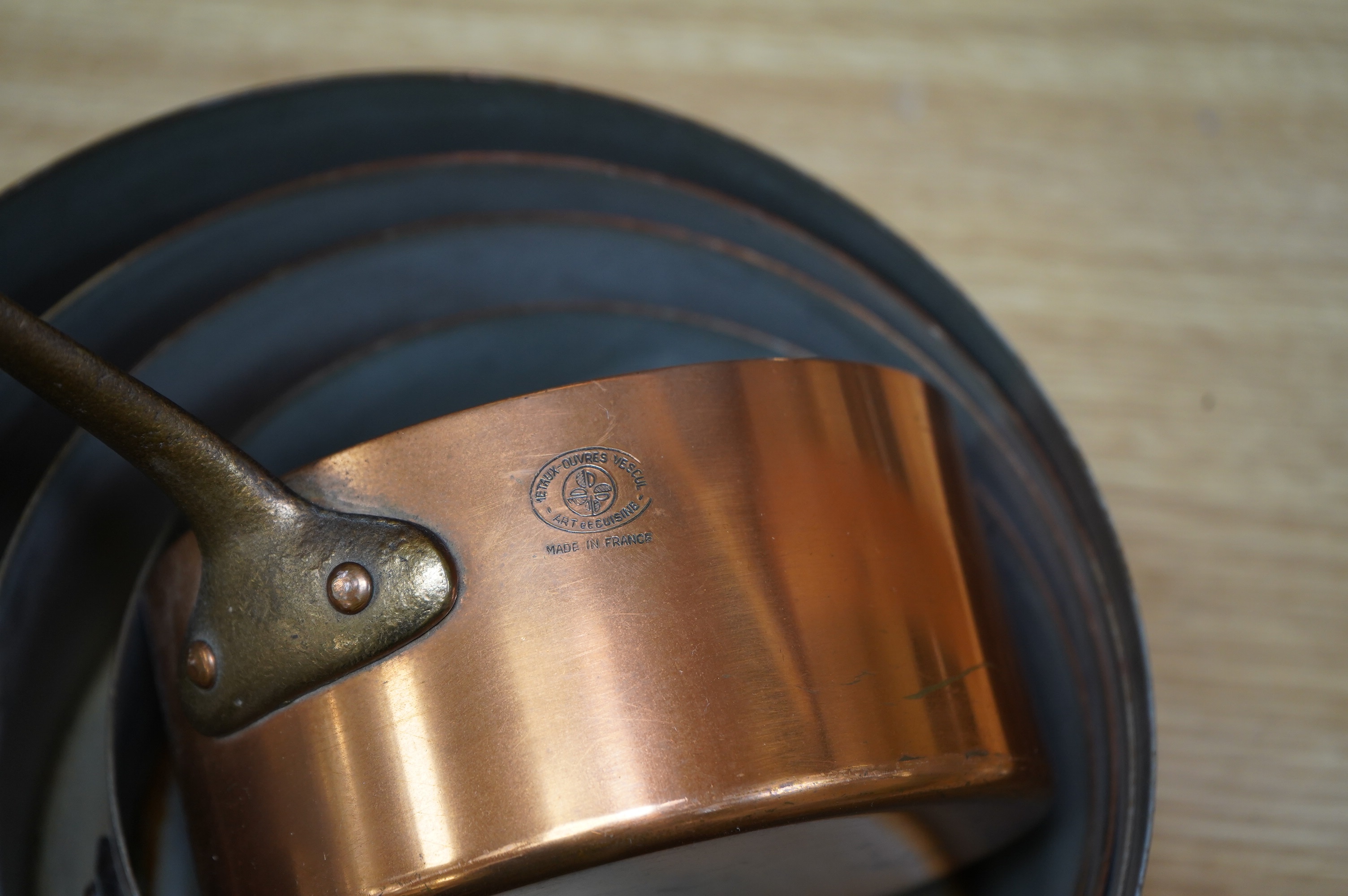 Les Metaux Ouvres. A graduated set of five copper pans. Condition - fair to good